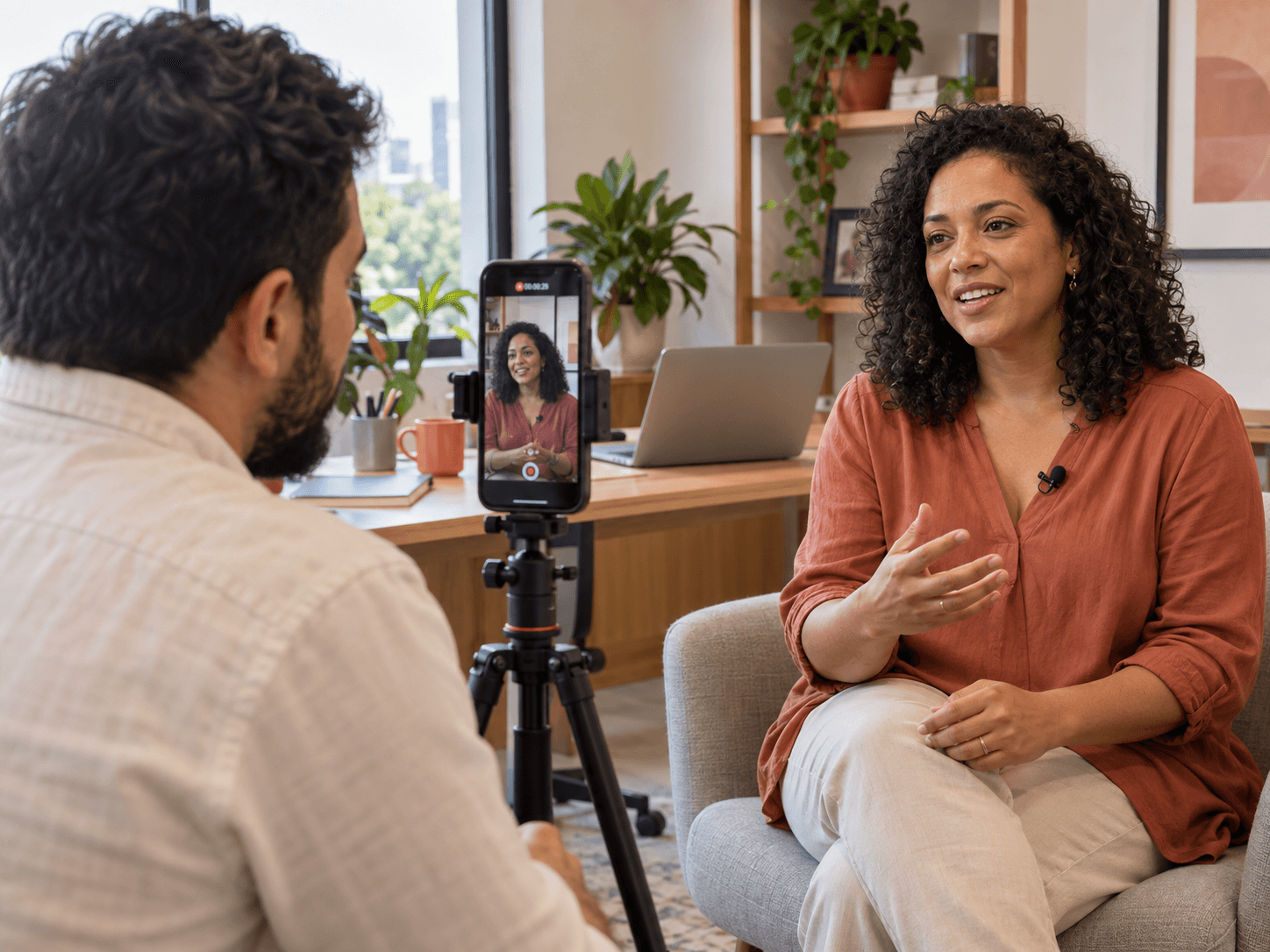 Parceira grava um vídeo de entrevista com o celular em um tripé